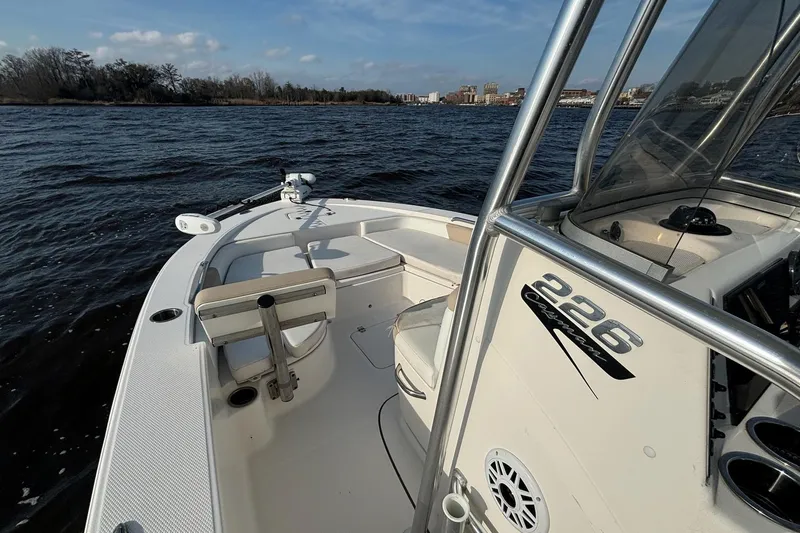 Slide: The Image of 2020 Robalo 226 Cayman boat on water, featuring sleek design and spacious deck. - 11