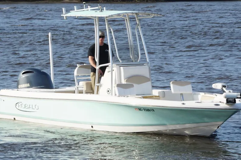 Slide: The Image of 2020 Robalo 226 Cayman boat on water with Yamaha engine, piloted by a person. - 3