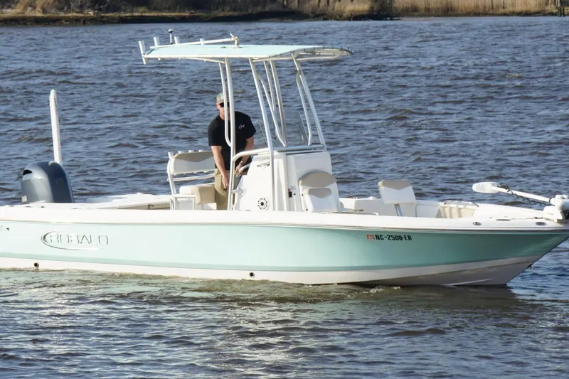 Slide: The Image of 2020 Robalo 226 Cayman boat cruising on a calm river. - 4