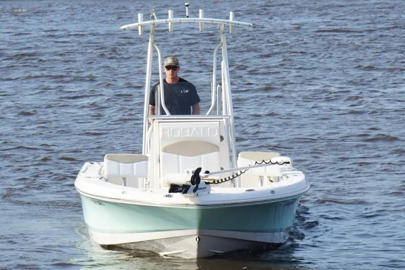 Slide: The Image of 2020 Robalo 226 Cayman boat cruising on open water. - 5