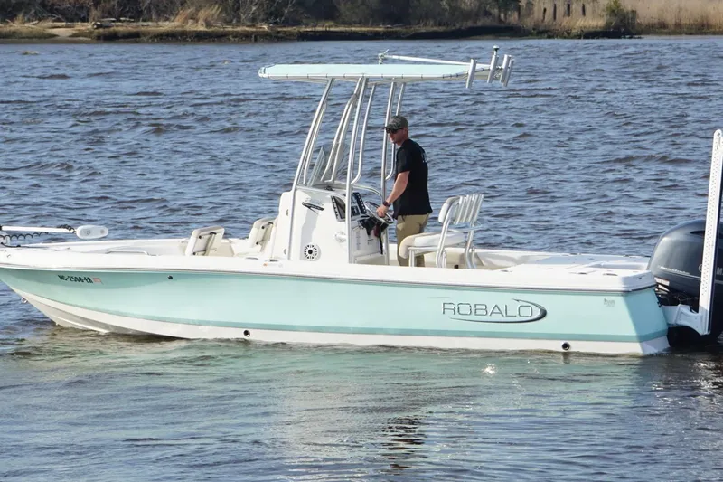 Slide: The Image of 2020 Robalo 226 Cayman boat on water, featuring a sleek design and T-top canopy. - 8