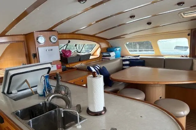 Slide: The Image of Interior of 2004 Soubise Plaisance Freydis 46 yacht with kitchen and seating area. - 10