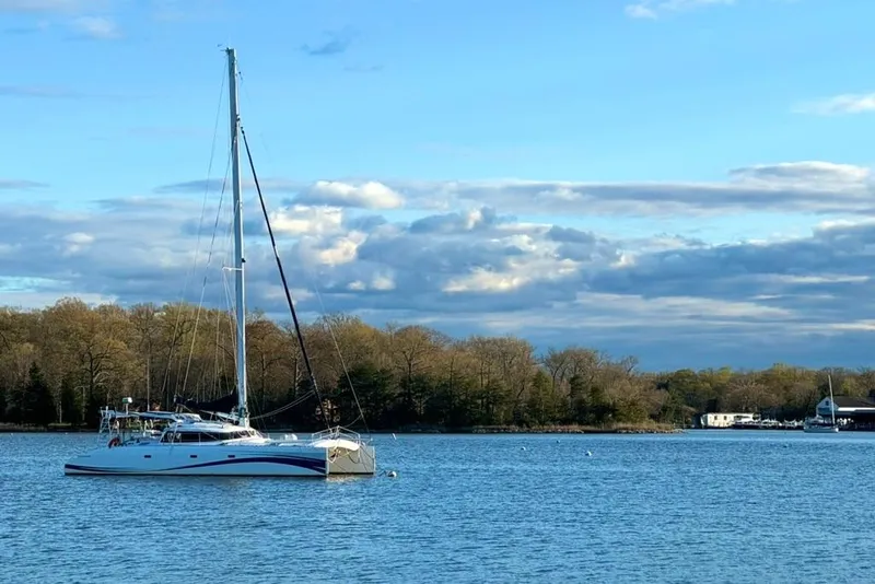 Slide: The Image of Soubise Plaisance Freydis 46 catamaran sailing on a serene lake, 2004 model. - 2