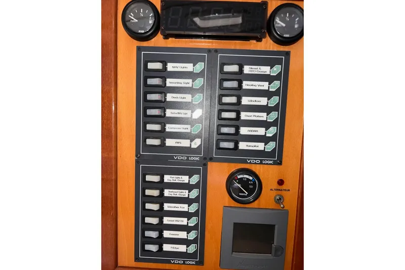 Slide: The Image of Control panel of a 2004 Soubise Plaisance Freydis 46 yacht with labeled switches and gauges. - 21