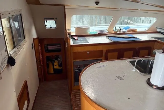 Slide: The Image of Interior of 2004 Soubise Plaisance Freydis 46 catamaran with kitchen and wooden cabinetry. - 9
