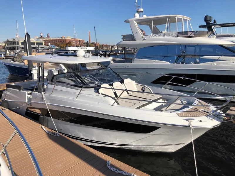 Slide: The Image of 2024 Jeanneau Leader 12.5 WA boat docked at marina, sleek design, sunny day. - 1