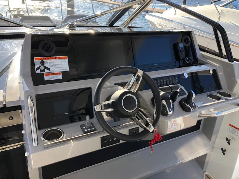 Slide: The Image of 2024 Jeanneau Leader 12.5 WA helm with modern controls and navigation equipment. - 14