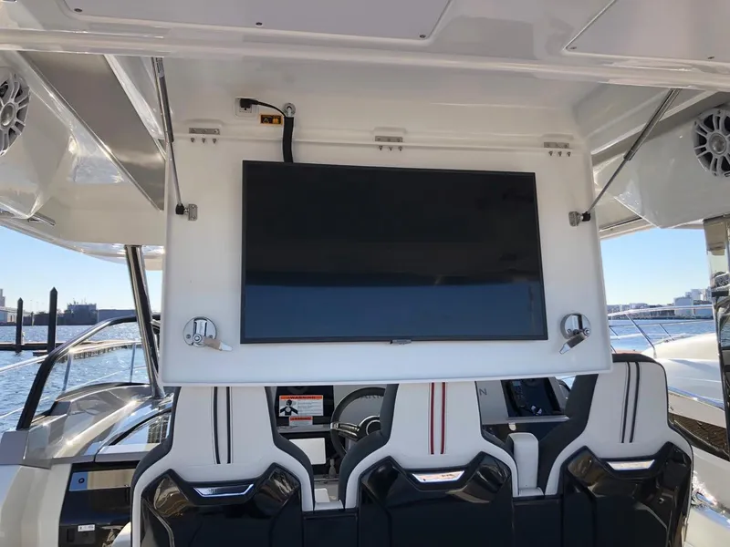 Slide: The Image of 2024 Jeanneau Leader 12.5 WA interior with mounted TV and sleek seating. - 19