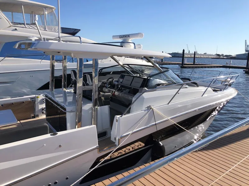 Slide: The Image of 2024 Jeanneau Leader 12.5 WA boat docked, showcasing sleek design and modern features. - 2