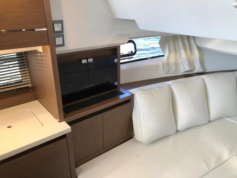Slide: The Image of Interior of 2024 Jeanneau Leader 12.5 WA yacht with modern seating and cabinetry. - 25