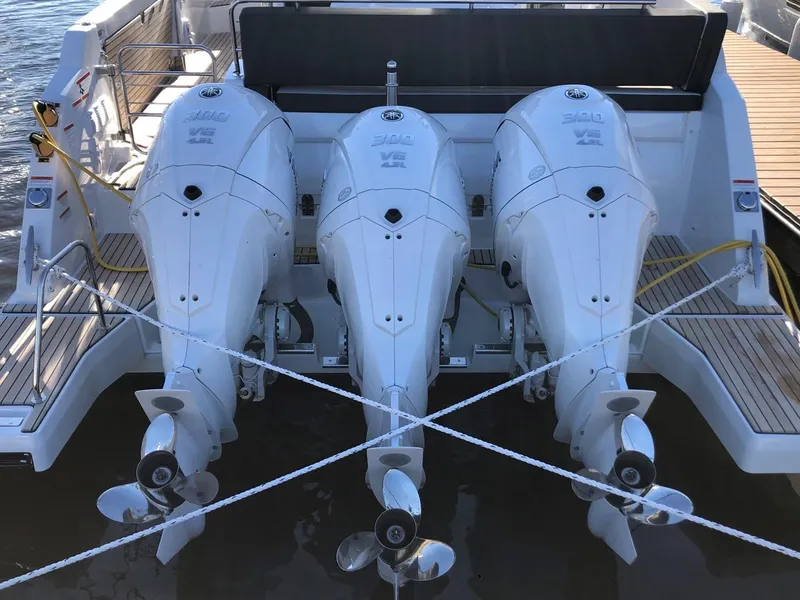 Slide: The Image of 2024 Jeanneau Leader 12.5 WA with triple outboard engines, docked at marina. - 3