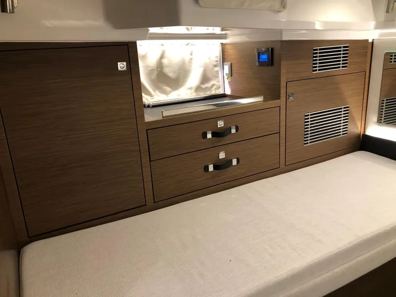 Slide: The Image of 2024 Jeanneau Leader 12.5 WA cabin interior with wood cabinetry and cushioned seating. - 30