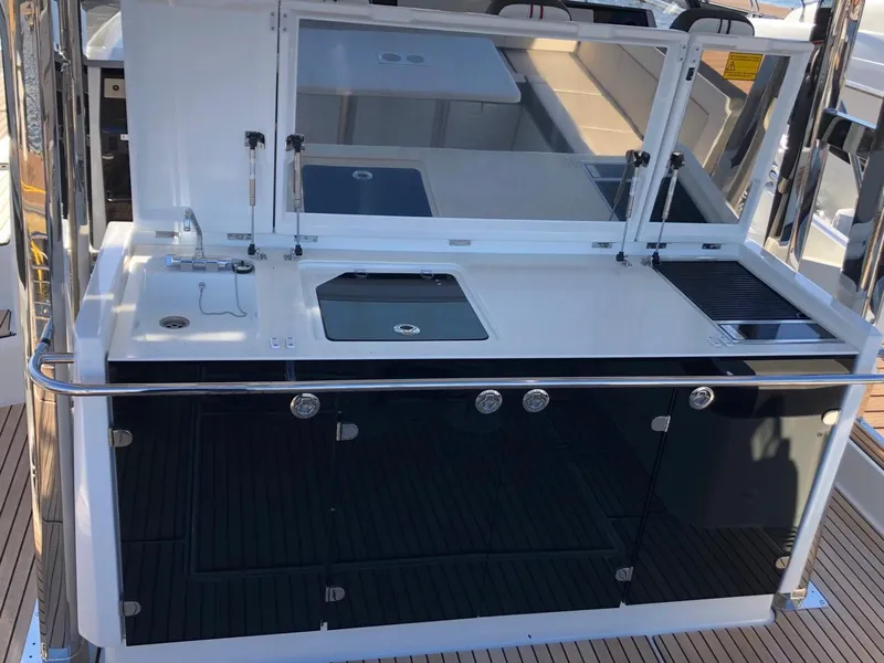 Slide: The Image of Outdoor kitchen on 2024 Jeanneau Leader 12.5 WA yacht, featuring sink and grill. - 4