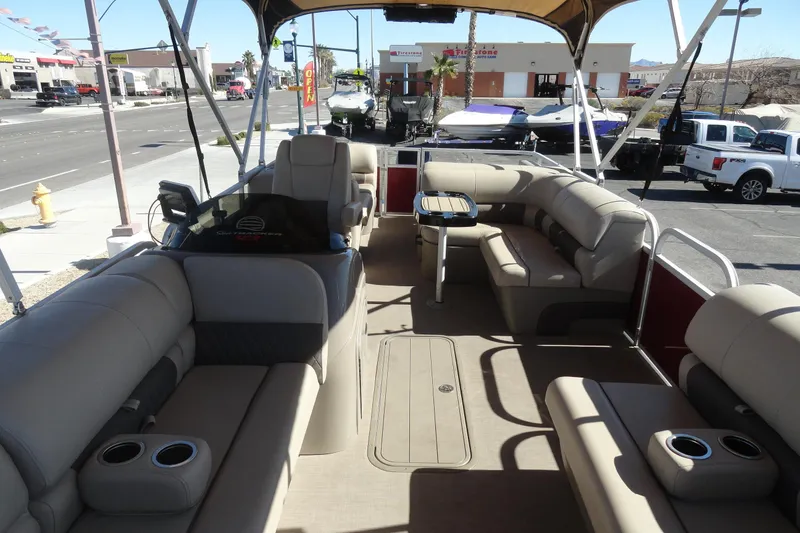 Slide: The Image of 2021 Sun Tracker Party Barge 22 XP3 interior with plush seating and steering console. - 18