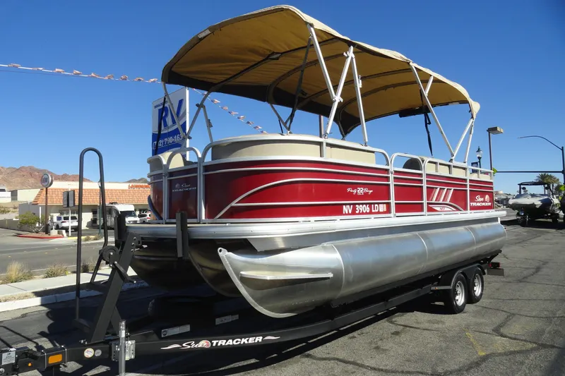 Slide: The Image of 2021 Sun Tracker Party Barge 22 XP3 pontoon boat on trailer, sunny day. - 2