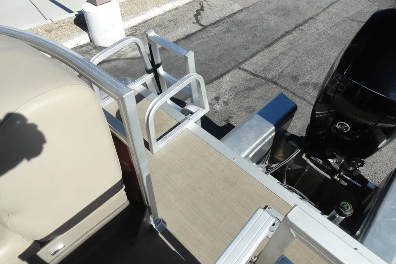 Slide: The Image of 2021 Sun Tracker Party Barge 22 XP3 on trailer in parking lot. - 23