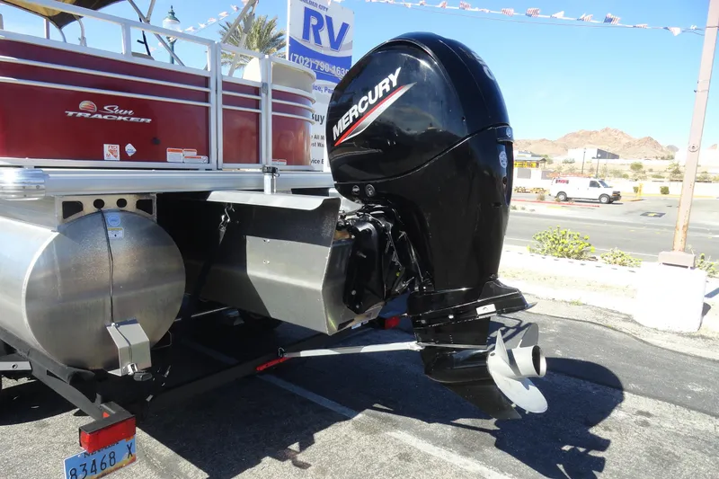 Slide: The Image of 2021 Sun Tracker Party Barge 22 XP3 pontoon boat with Mercury outboard motor in a parking lot. - 26