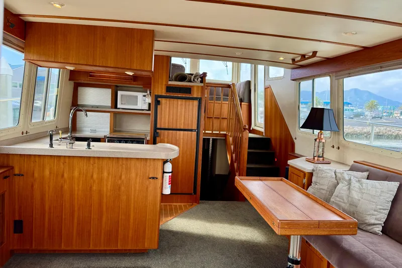 Slide: The Image of Interior of 2004 Nordic Tug 42 with wooden cabinetry and cozy seating area. - 10