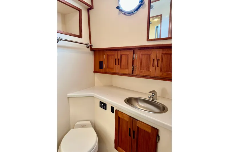 Slide: The Image of Bathroom interior of 2004 Nordic Tug 42 with wooden cabinets and stainless steel sink. - 18