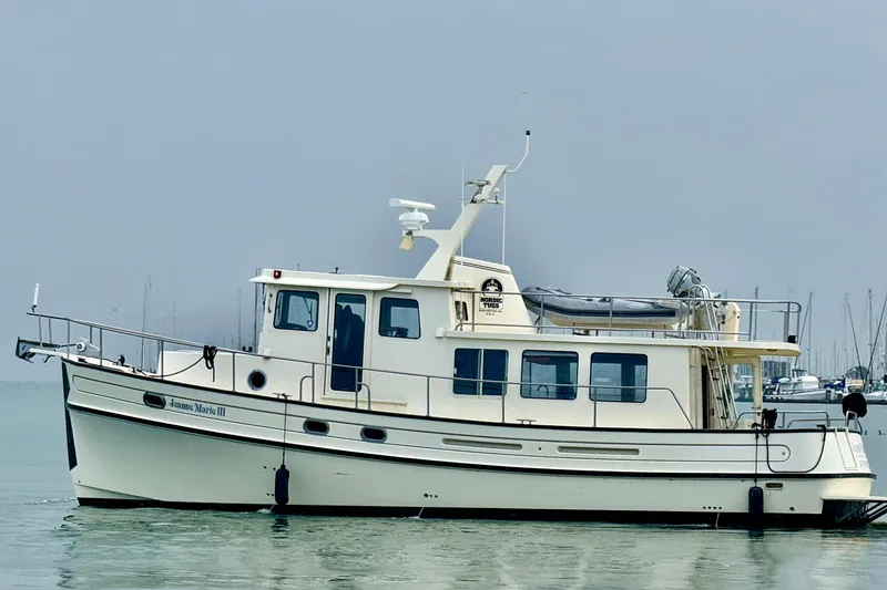 Slide: The Image of 2004 Nordic Tug 42 boat on calm water, side view. - 2