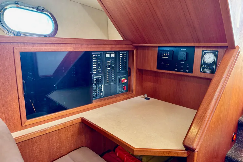 Slide: The Image of 2004 Nordic Tug 42 interior with control panel and wooden cabinetry. - 20