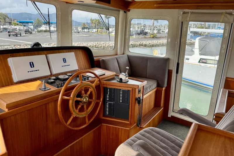 Slide: The Image of 2004 Nordic Tug 42 helm with wooden wheel and Furuno navigation displays. - 26