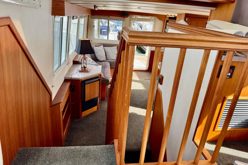 Slide: The Image of Interior of 2004 Nordic Tug 42 with wooden finishes and cozy seating area. - 27