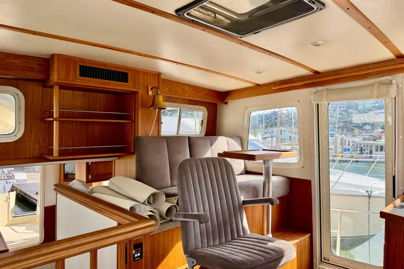 Slide: The Image of Interior of 2004 Nordic Tug 42 with wood accents and seating area. - 28