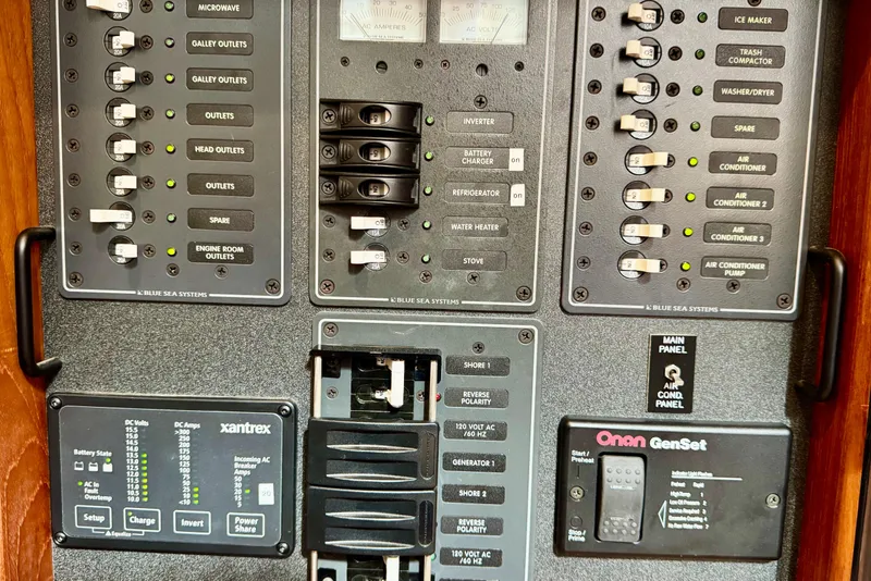 Slide: The Image of Electrical control panel on a 2004 Nordic Tug 42 boat, featuring various switches and indicators. - 32