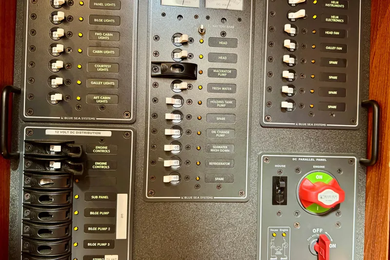 Slide: The Image of Electrical control panel of a 2004 Nordic Tug 42 boat with labeled switches. - 33