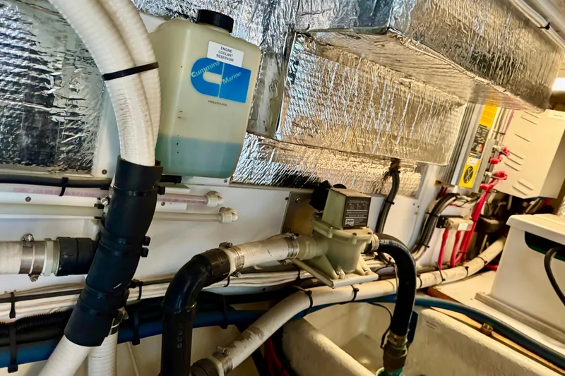 Slide: The Image of Engine room of 2004 Nordic Tug 42 with coolant reservoir and insulated pipes. - 38