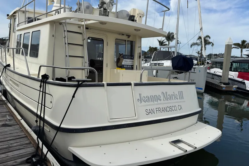 Slide: The Image of 2004 Nordic Tug 42 docked, named "Jeanne Marie III," in San Francisco marina. - 47