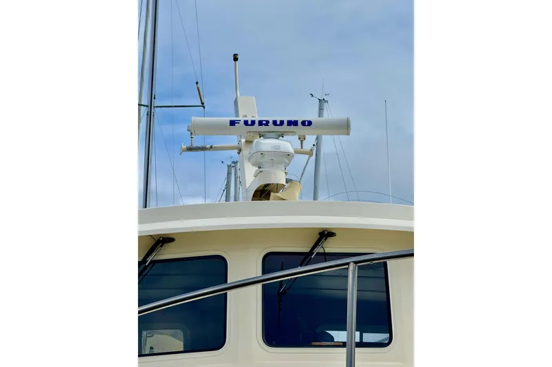 Slide: The Image of 2004 Nordic Tug 42 with Furuno radar system against a cloudy sky. - 48