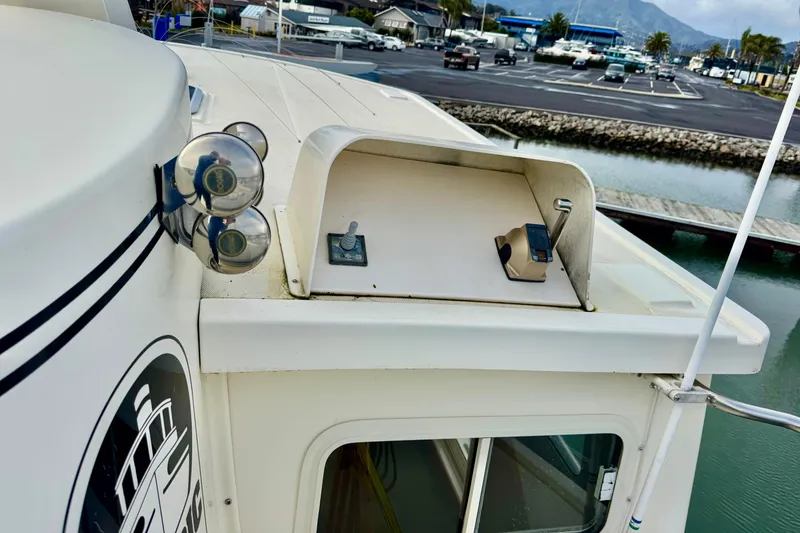 Slide: The Image of 2004 Nordic Tug 42 boat roof with spotlight and control panel at marina. - 50