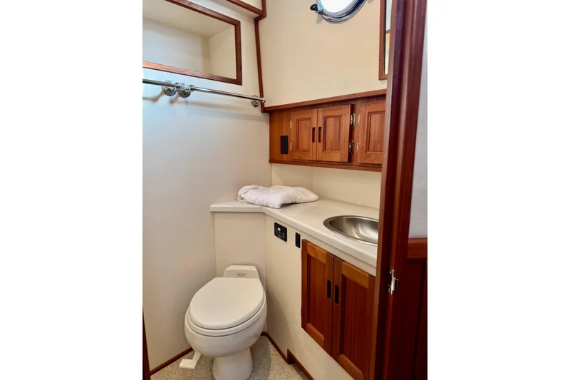 Slide: The Image of Bathroom interior of 2004 Nordic Tug 42 with wooden cabinets and stainless steel sink. - 56