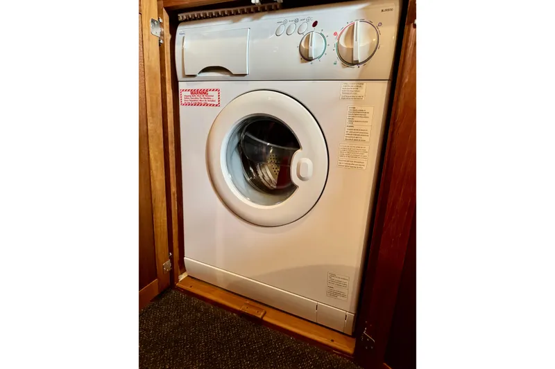 Slide: The Image of Compact washing machine in a 2004 Nordic Tug 42 boat interior. - 58