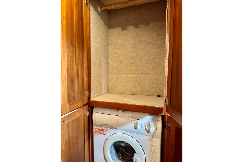 Slide: The Image of Wooden cabinet with built-in washing machine on a 2004 Nordic Tug 42 boat. - 59
