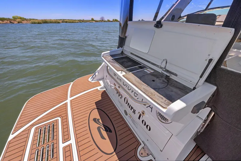 Slide: The Image of 2014 Sea Ray 350 Sundancer boat with outdoor kitchen on deck, cruising on a sunny day. - 12