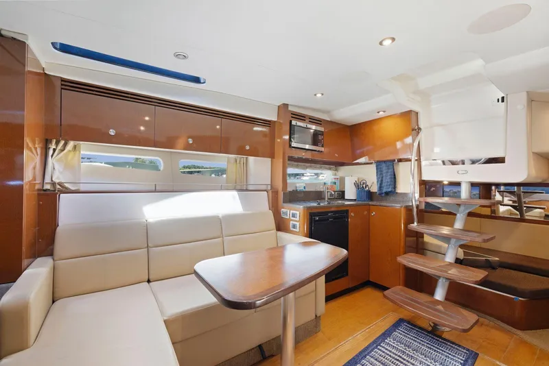 Slide: The Image of Interior of 2014 Sea Ray 350 Sundancer yacht with modern kitchen and seating area. - 22