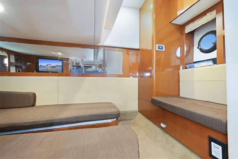 Slide: The Image of Interior of 2014 Sea Ray 350 Sundancer yacht with modern furnishings and porthole window. - 30