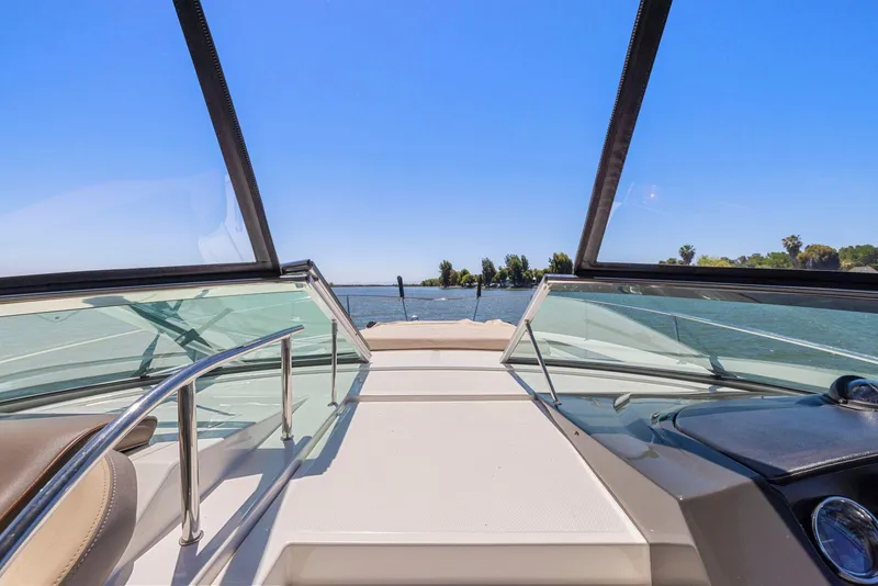 Slide: The Image of 2014 Sea Ray 350 Sundancer boat deck with clear blue sky and water view. - 8