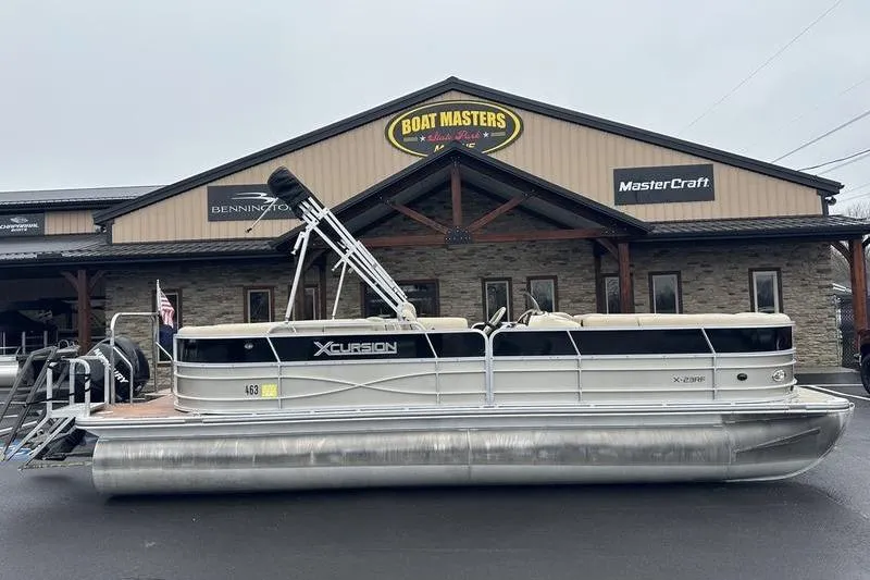 Slide: The Image of 2012 Xcursion X23RF pontoon boat parked outside Boat Masters dealership. - 1
