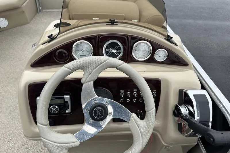 Slide: The Image of Steering console of 2012 Xcursion X23RF boat with gauges and controls. - 14