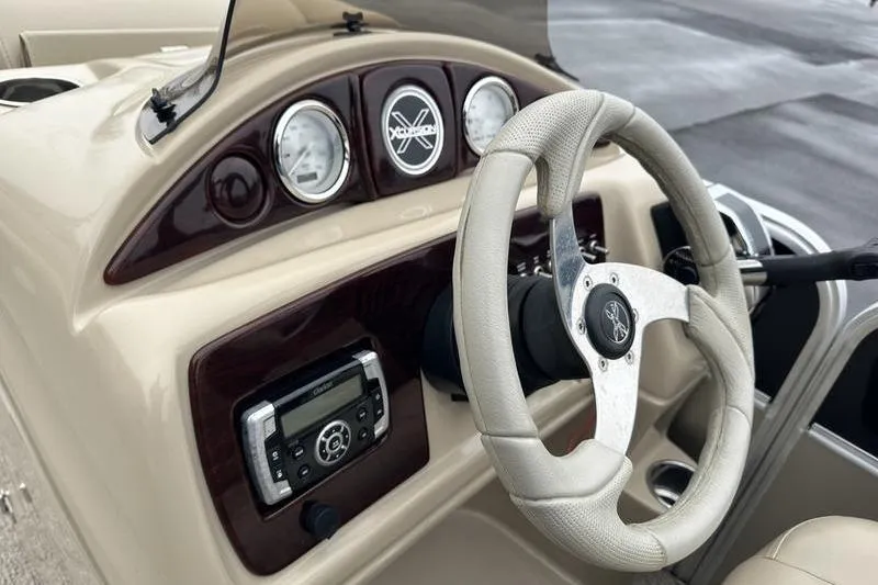 Slide: The Image of Steering console of 2012 Xcursion X23RF boat with gauges and audio system. - 19