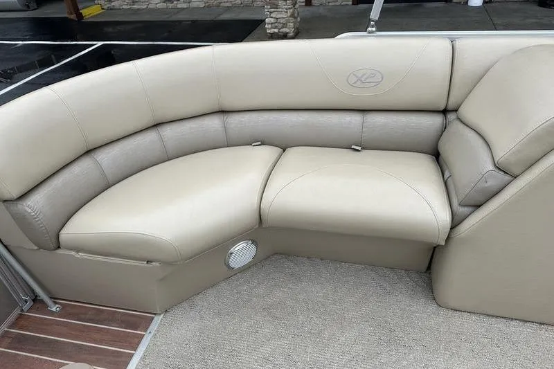 Slide: The Image of 2012 Xcursion X23RF boat interior with beige leather seating and carpeted floor. - 22