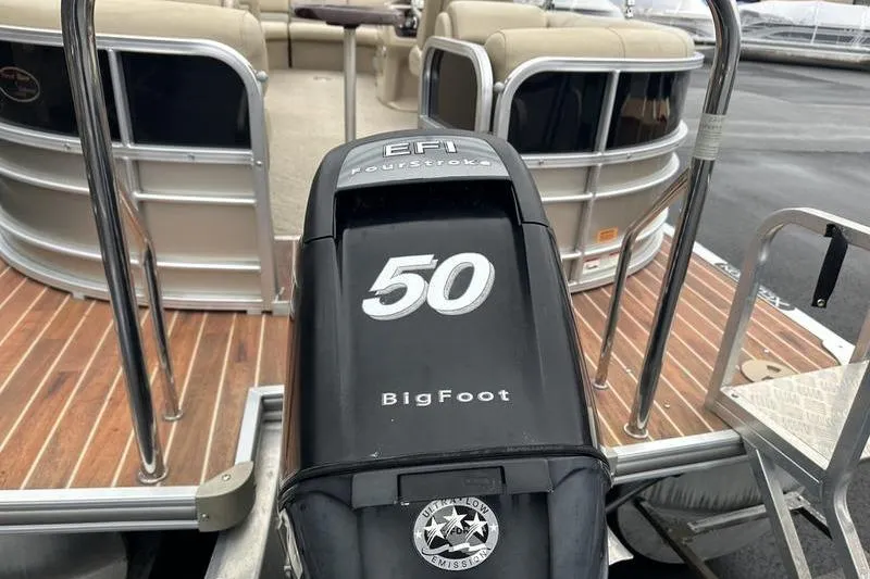 Slide: The Image of Outboard motor on 2012 Xcursion X23RF pontoon boat, featuring EFI FourStroke technology. - 3