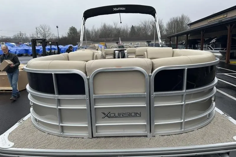 Slide: The Image of 2012 Xcursion X23RF pontoon boat with beige seating and black canopy in a parking lot. - 8