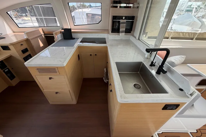 Slide: The Image of Modern kitchen interior of 2025 C-Catamarans 48 with sleek countertops and stainless steel sink. - 24