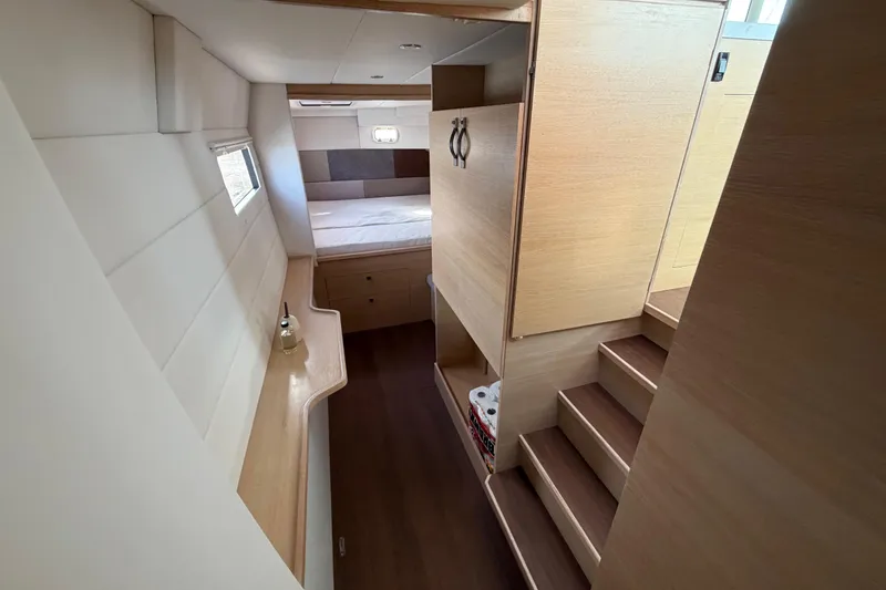 Slide: The Image of Interior of 2025 C-Catamarans 48, featuring modern wood finishes and cozy sleeping area. - 27