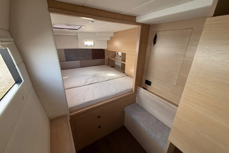 Slide: The Image of Modern interior of 2025 C-Catamarans 48, featuring a cozy bedroom with natural wood finishes. - 28